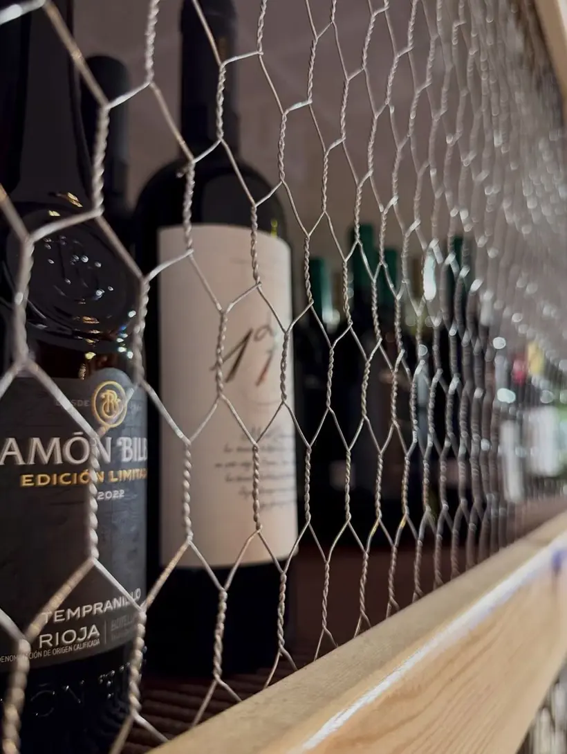 Botellas de vino tras una malla